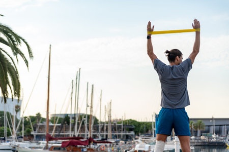 Young latin man doing exercise outside