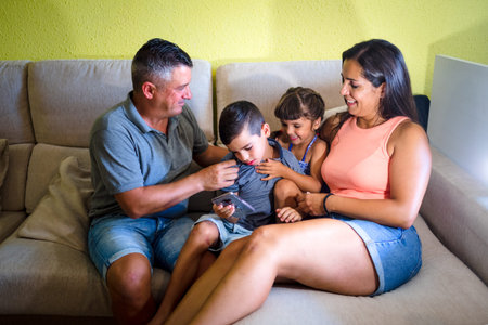 Family with children having fun at home