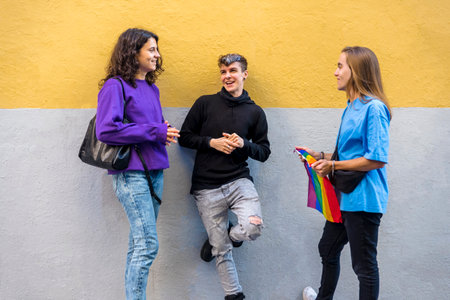 Young diverse friends talking outdoors on the street.の写真素材