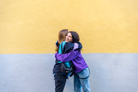 Young friends hugging outdoors on the street.の写真素材