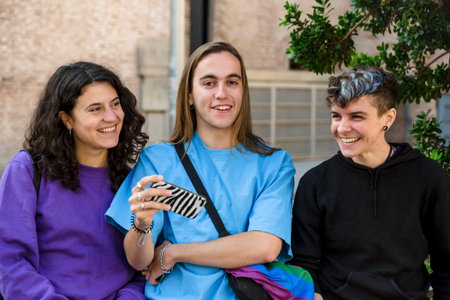 Young diverse friends taking selfie with a mobile phone outdoors.