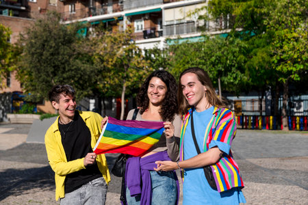 Young diverse friends walking on the street with the lgbt rainbow flag.の写真素材