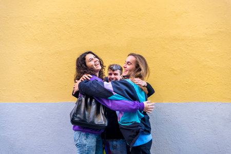 Young diverse friends talking outdoors on the street.の写真素材