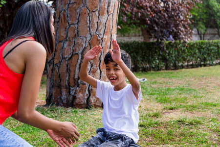Mother and son having fun together while enjoying a day in the park.の写真素材