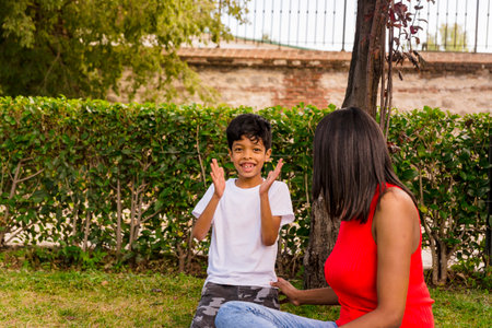Mother and son having fun together while enjoying a day in the park.の写真素材