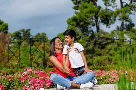 Mother and son having fun together while enjoying a day in the park.の写真素材