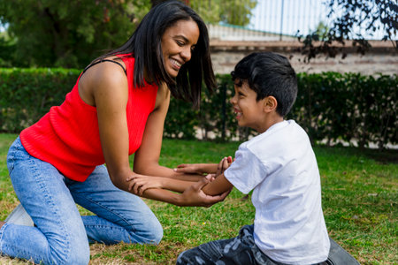 Mother and son having fun together while enjoying a day in the park.の写真素材