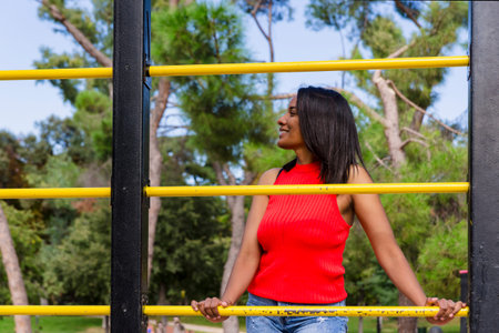 Young mother smiling outdoors in a park.