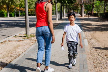 Happy mother and son enjoying together outdoors in a park.の写真素材