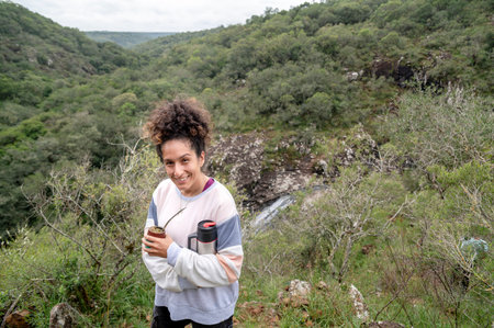 Mixed race woman smiling while enjoying the day outdoors in nature.