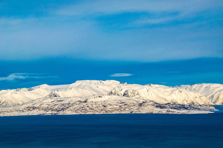 Beautiful view of the snow-capped mountains and the sea