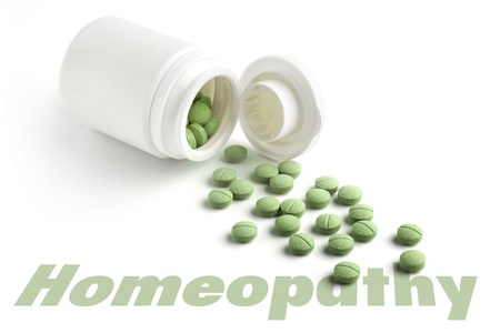 close up of bottle of homeopatic tablets on white backgroundの写真素材