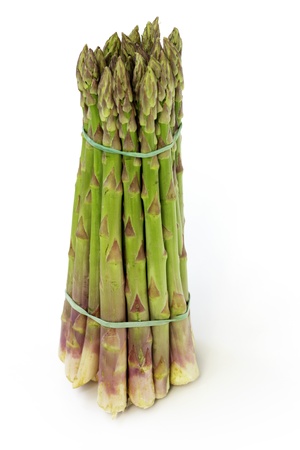 asparagus tied in a bunch on white backgroundの写真素材