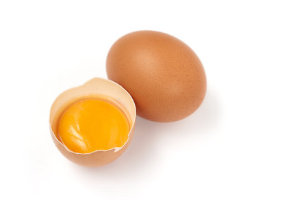 egg yolk and whole egg isolated on white background