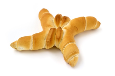 cross-shaped baked bread isolated on white backgroundの写真素材