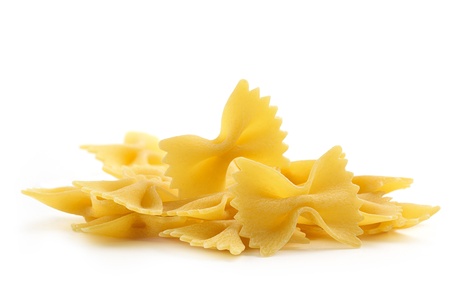 heap of bow tie pasta on white backgroundの写真素材