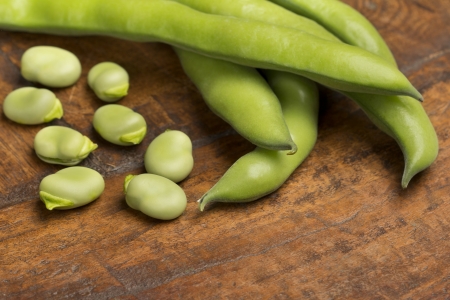 close up of broad beans on wooden backgroundの写真素材