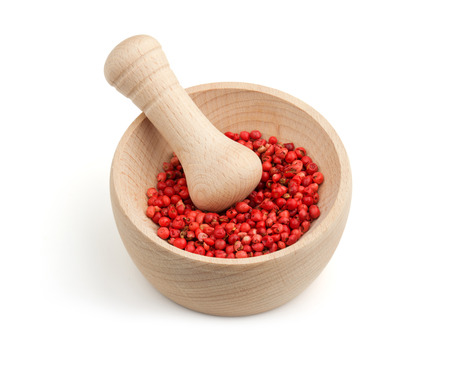 red pepper in a mortar with pestle on white backgroundの写真素材