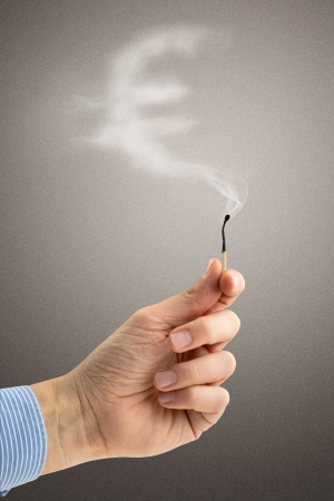 extinguished matchstick with a wisp of smoke euro-shapedの写真素材