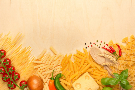 assortment of pasta, emmental and fresh vegetablesの写真素材