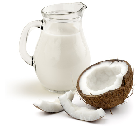 jug of coconut milk and half coconut on white backgroundの写真素材