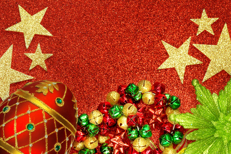 Christmas tree ornaments on red glitter backgroundの写真素材