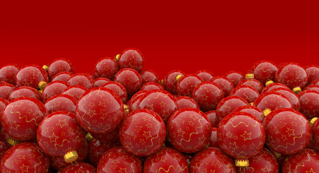 heap of christmas baubles on red backgroundの写真素材