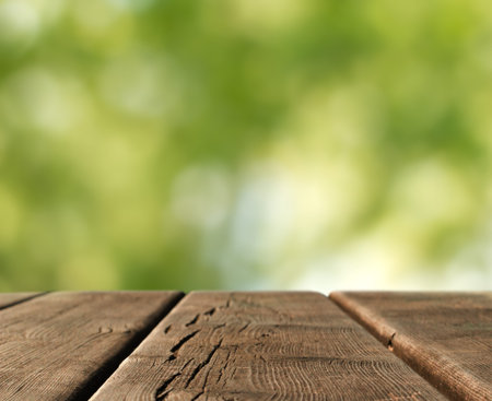 wooden table top in a blurred country landscape