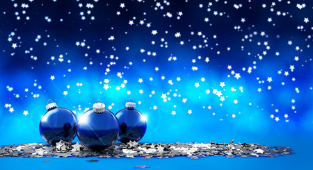 three christmas balls in a starry backgroundの写真素材