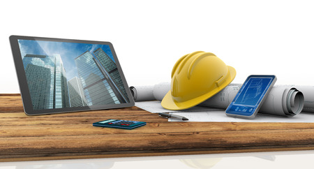 tablet, smartphone, safety helmet and blueprints on wooden table