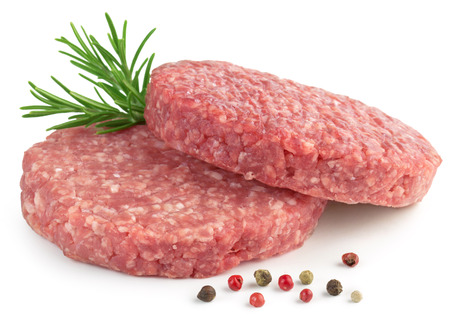 two raw hamburger, rosemary and pepper on white backgroundの写真素材