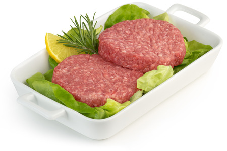 two hamburgers and lettuce in porcelain trayの写真素材