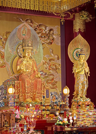altar with ornate statues of buddha inside templeのeditorial素材