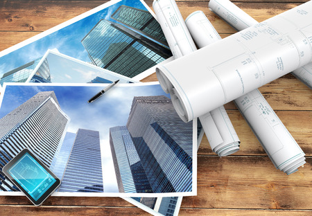 blueprints and pictures of skyscrapers on wooden backgroundの写真素材