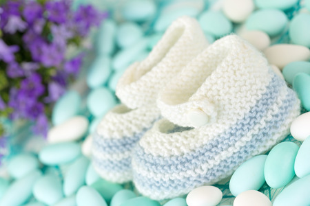 close up of wool baby shoes on sugared almondsの写真素材