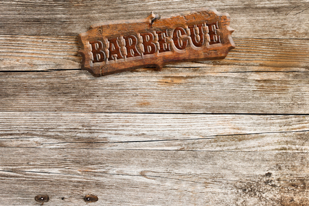 barbecue signboard nailed to a wooden panelの写真素材
