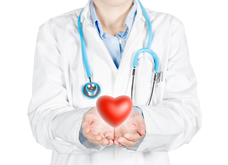 female doctor holding a red heart isolated on whiteの写真素材