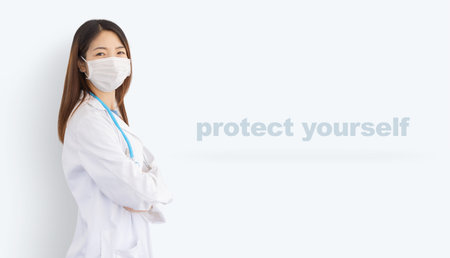 beautiful asian woman wearing white coat, protective mask and stethoscope isolated on background...