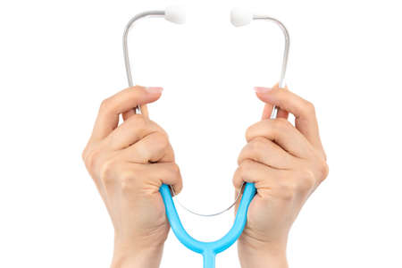 female hands holding a stethoscope isolated on a white background with text space, conceptual icon of medicine and health care equipmentの写真素材