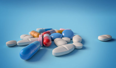 Close up of capsules, pills and tablets on blue background, 3d illustration. Concept about...