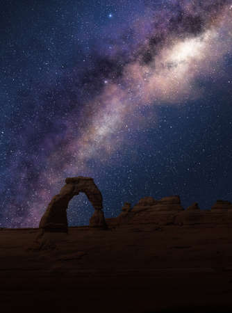 Delicate Arch under the Milky Way in a starry night sky. Arches National Park, Utah.の写真素材
