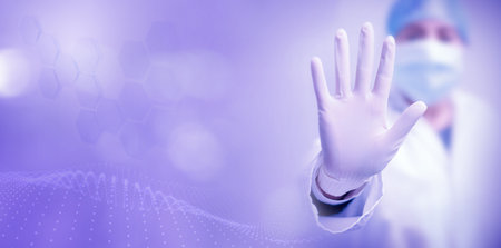 Female doctor wearing mask and gloves makes the stop gesture on lilac background with space for text.の写真素材