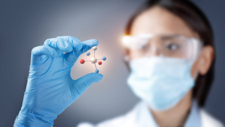 Woman chemist holding and examining a 3d illustration of molecular model. Biotechnology research and biochemistry discovery.の写真素材