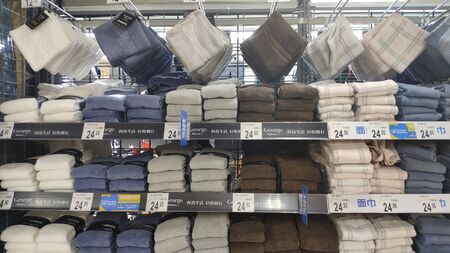 Shelf with bath towels in supermarket in Guangzhou Chinaのeditorial素材