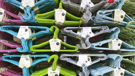 Colorful wire coat hangers on sale in supermarketのeditorial素材
