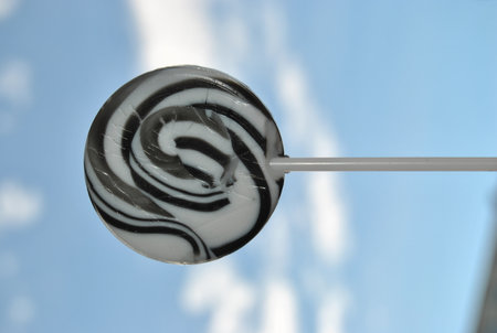 lollipop on a stick against the background of the blue skyの写真素材