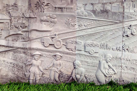 Hoi An, Vietnam, February 29, 2020: Detail of a reliebe mural representing the work of the Vietnamese people during the Vietnam War. Martyrs Cemetery in Hoi An, Vietnam.のeditorial素材