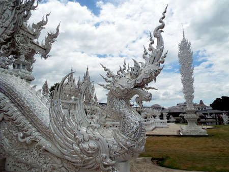 Chiang Rai. Thailand, June 17, 2017: Wat Rong Khun. One of the dragon-shaped nagas at the White Temple in Chiang Rai, Thailand. Designed by Don Chalermchai Kositpipatのeditorial素材