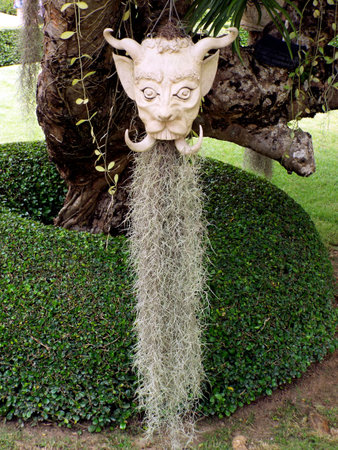 Chiang Rai. Thailand, June 17, 2017: Wat Rong Khun. Head hangs from a tree at the White Temple in...