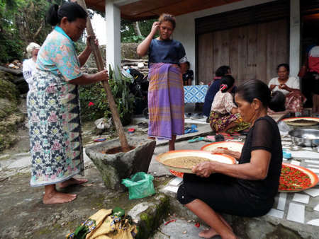 Pulau Samosir, Lake Toba, Sumatra, Indonesia, January 12, 2018: Several women handle food in the yard of a house by Lake Toba, Pulau Samosir. Indonesiaのeditorial素材